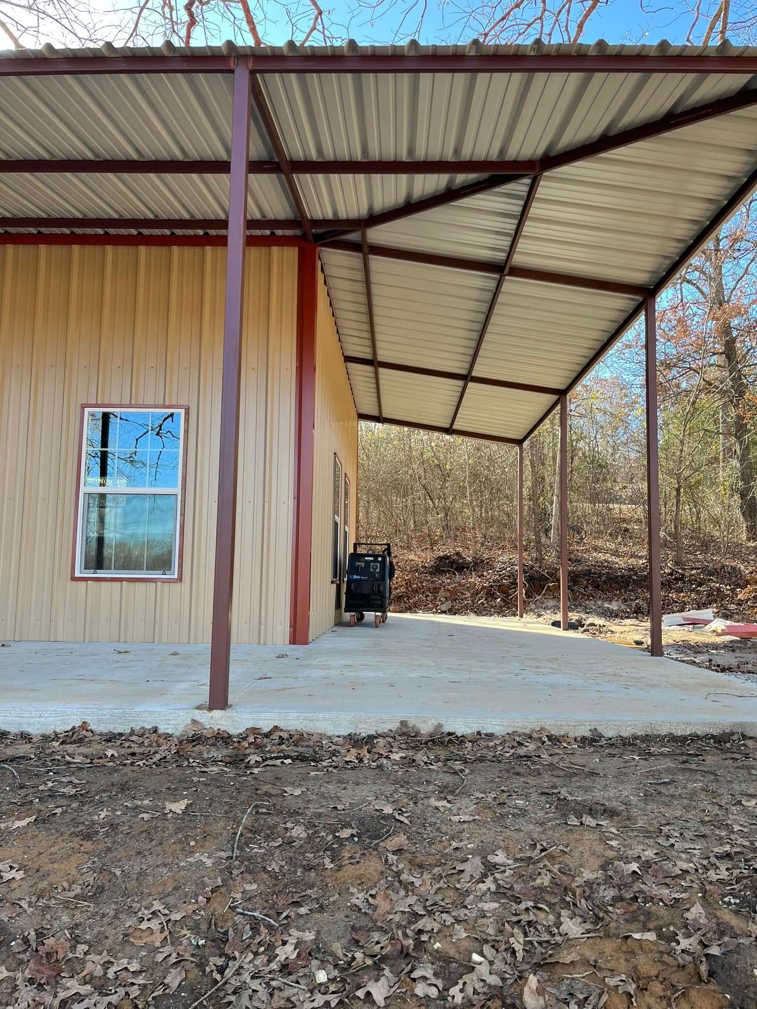A house with a covered porch and a window in the woods.