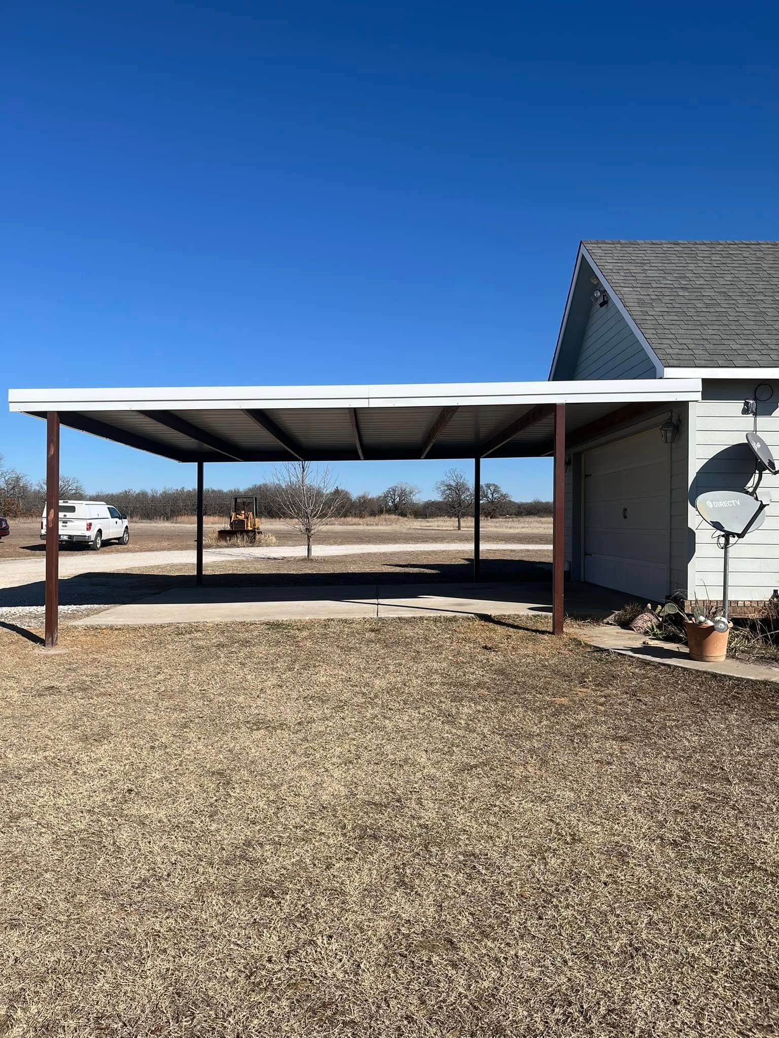 There is a carport in the backyard of a house.