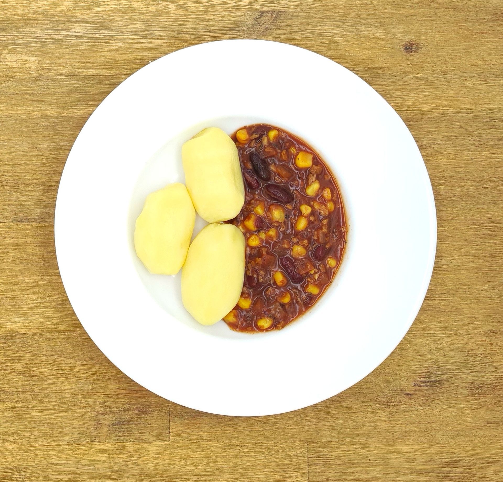 Kochraupe mit einem Teller, auf dem „Bild folgt“ steht