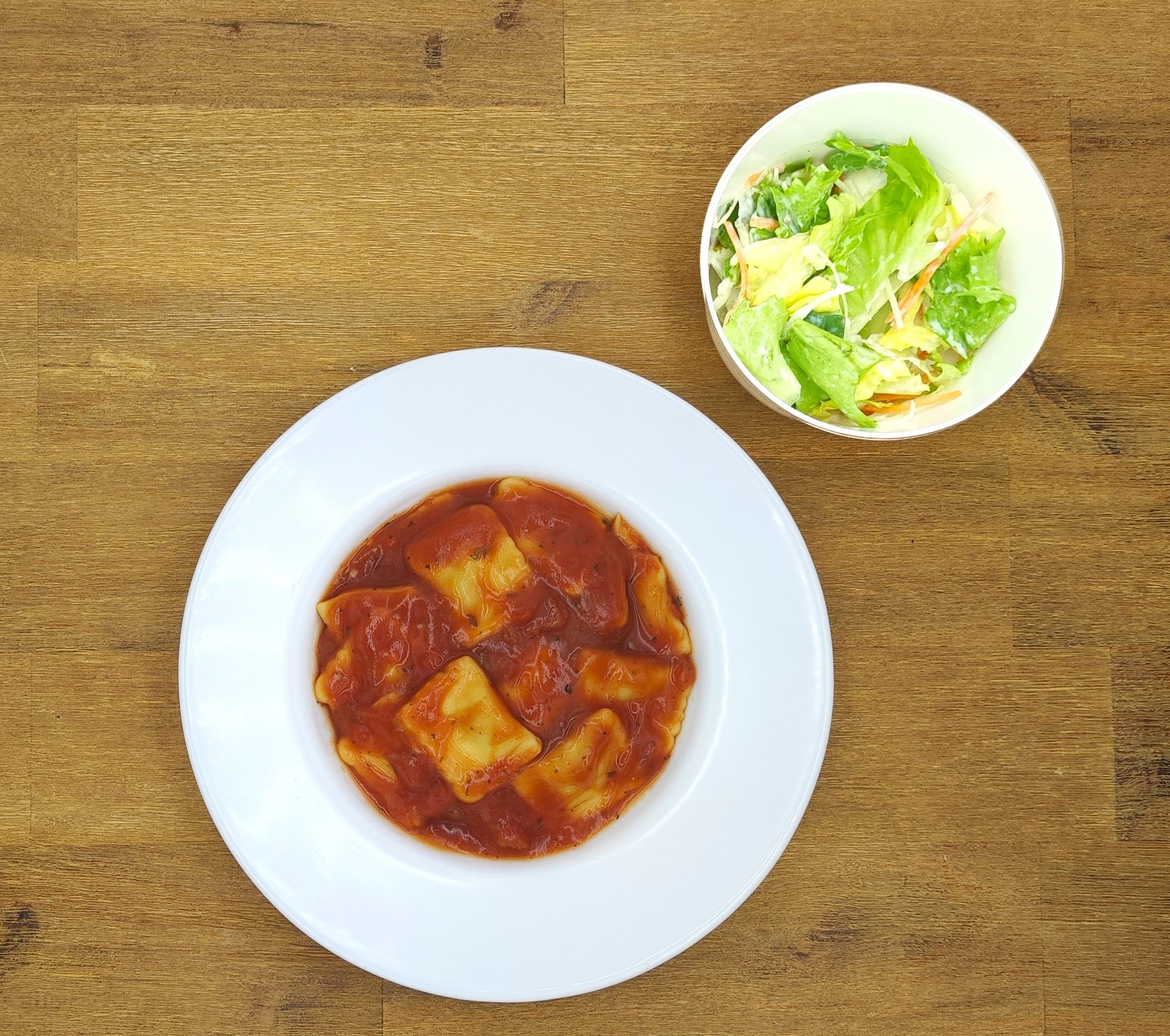 Eine ausgestopfte Raupe mit Kochmütze neben einem Teller mit der Aufschrift „Bild folgt“.