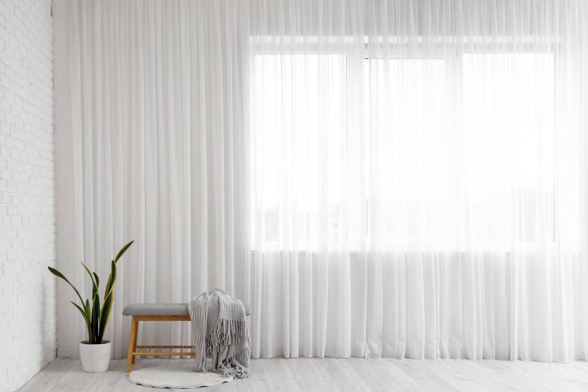 A light curtain near a plant, bench, blanket, and rug at Awnings, Blinds, and Shutters By Albert’s South Jersey Wallpaper near Haddon Heights, New Jersey (NJ)