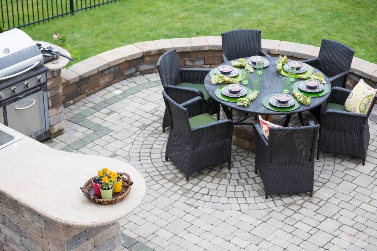 An elegant outdoor patio with a grill and a table for six people at Albert's South Jersey near Turnersville, New Jersey