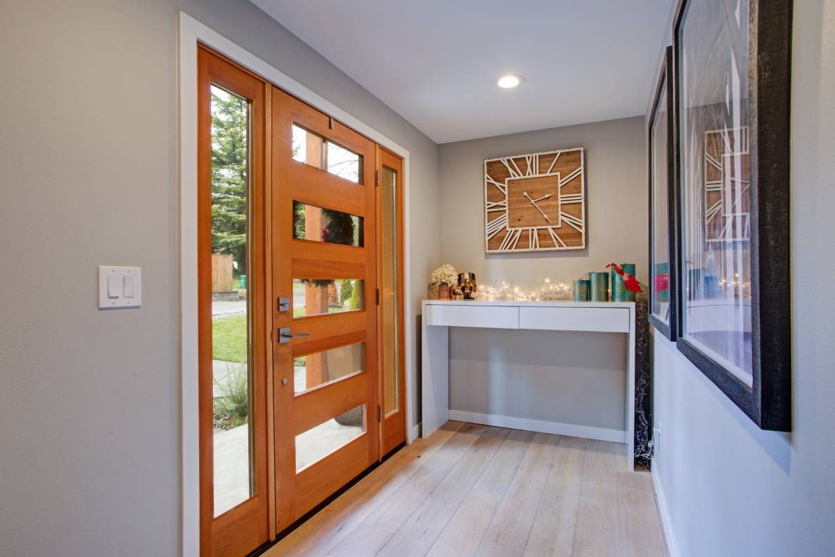 An elegant entryway with a glass-paneled door and sidelights at Awnings, Blinds, & Shutters near Turnersville, NJ