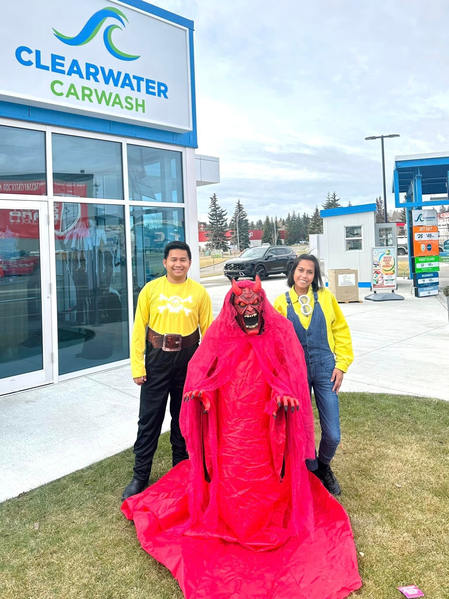 ClearWater staff pose with someone in a devil costume