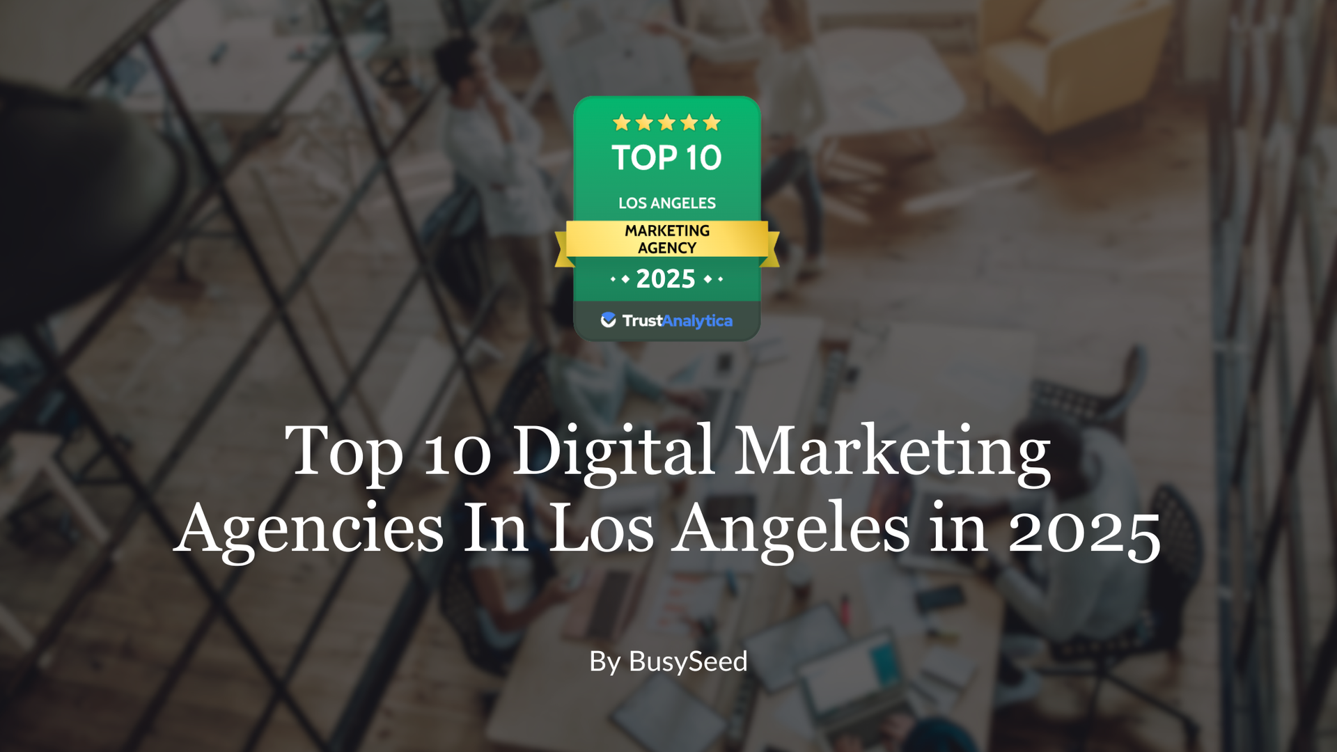 A group of people are sitting around a table having a meeting.