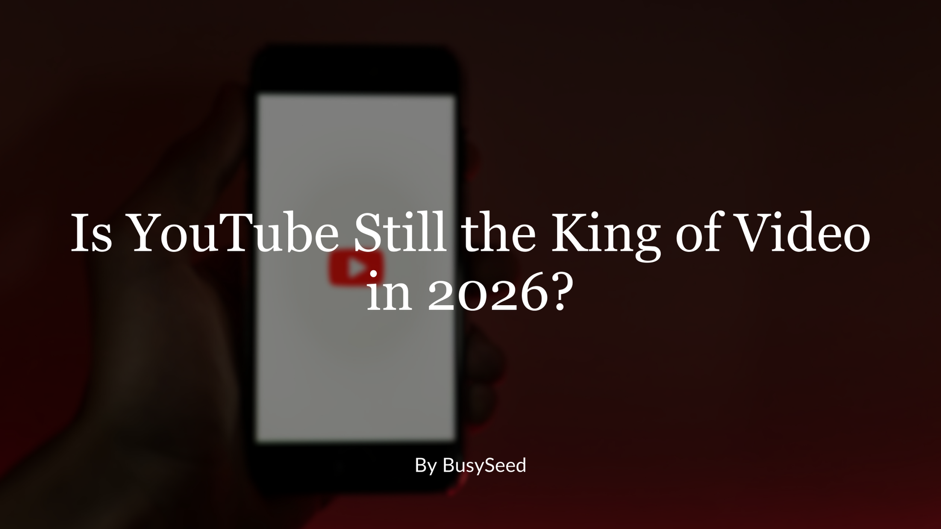 A hand holds a smartphone displaying the YouTube logo against a dark red background with the text, 