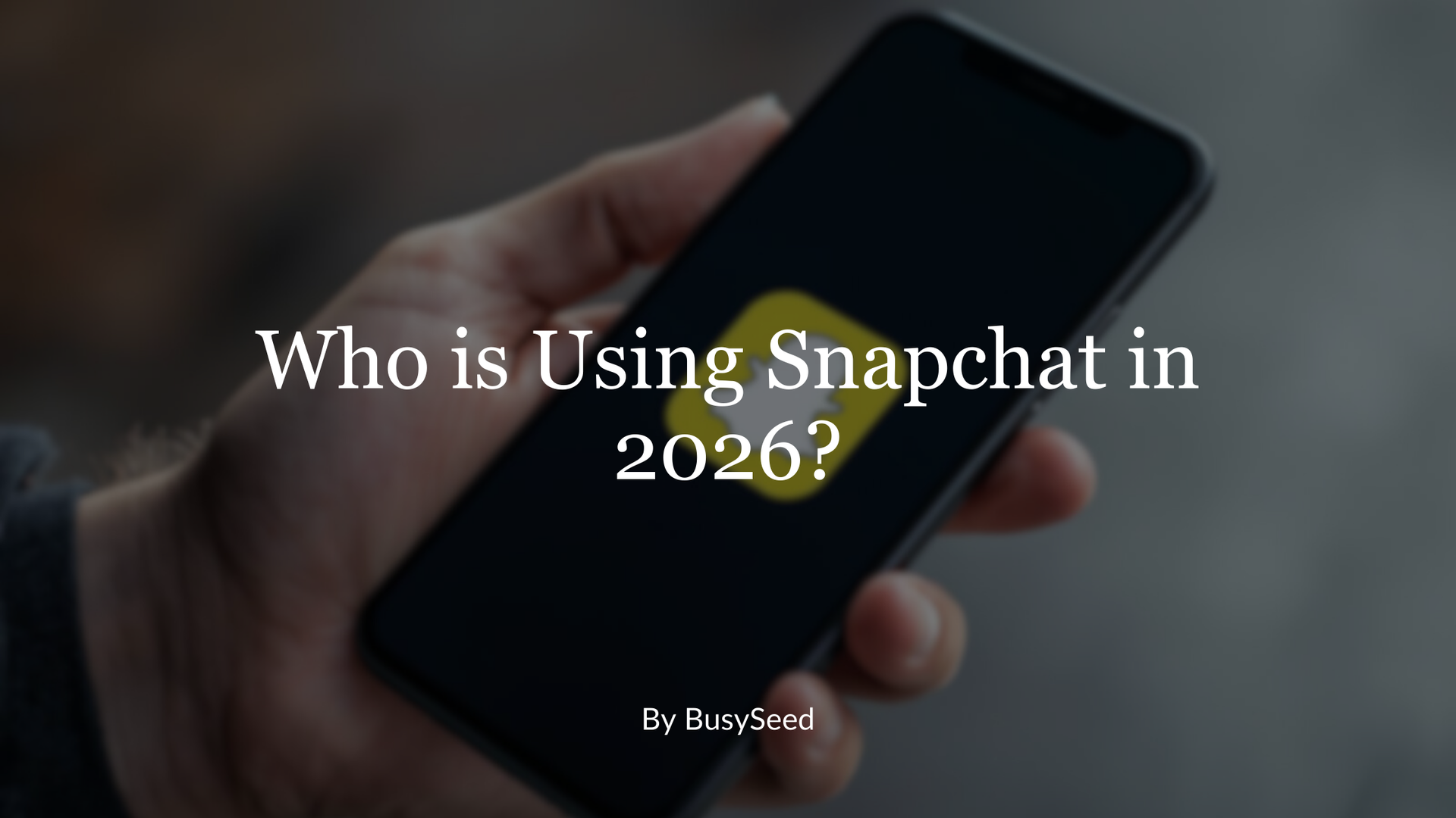 A hand holds a smartphone displaying the yellow Snapchat logo, with text overlay reading 