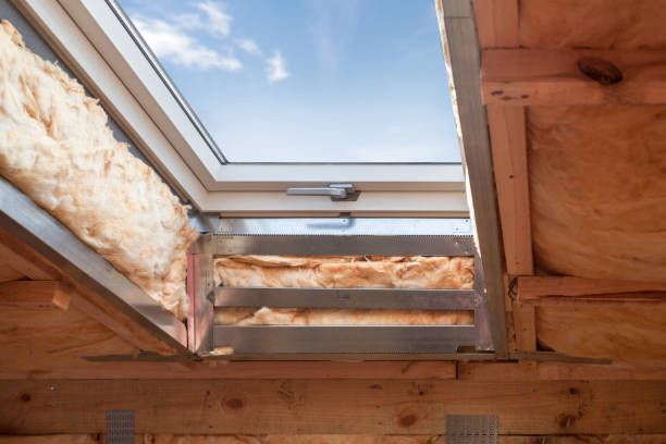 A skylight in the ceiling of a house under construction.