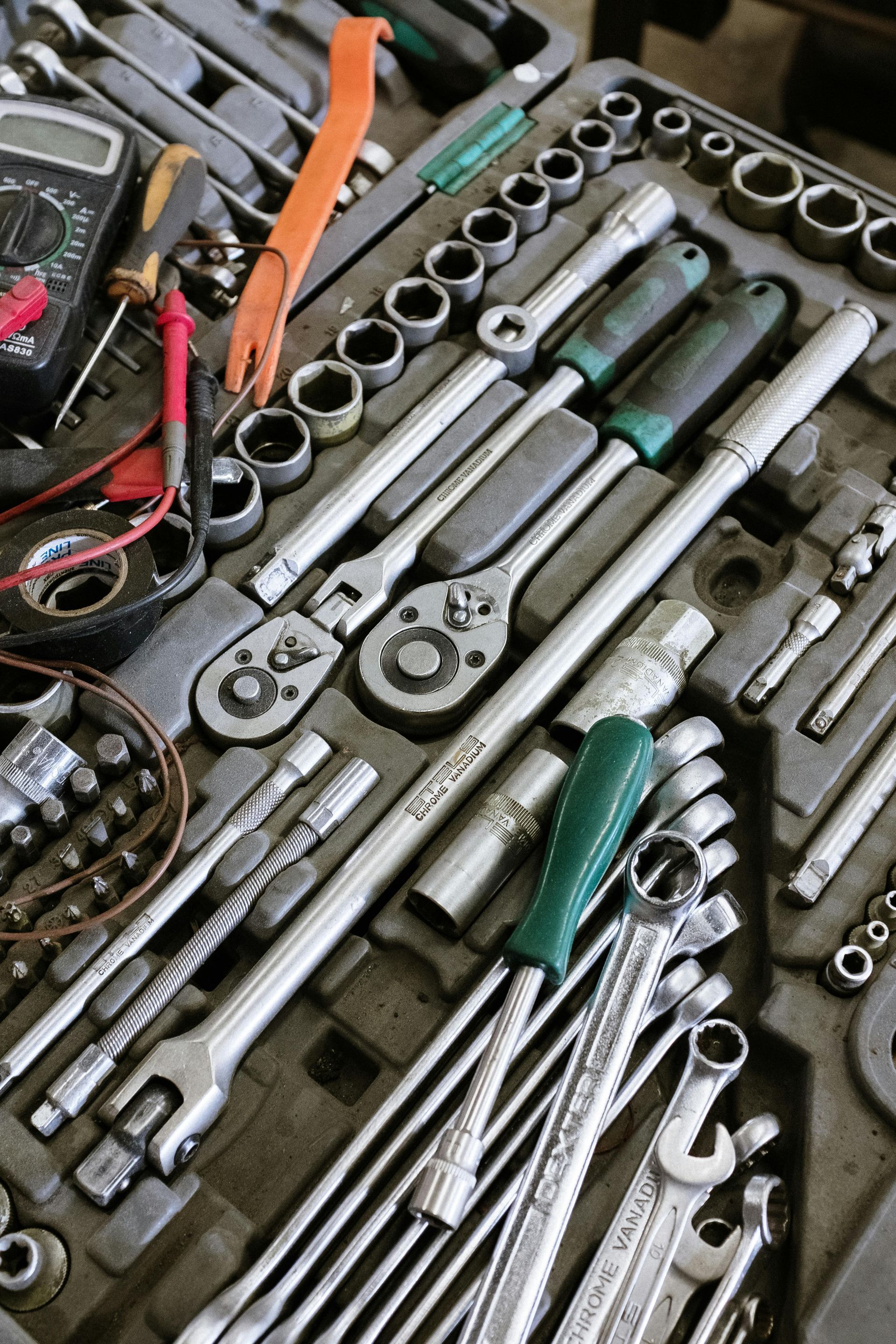 A bunch of tools are sitting on top of each other on a table.