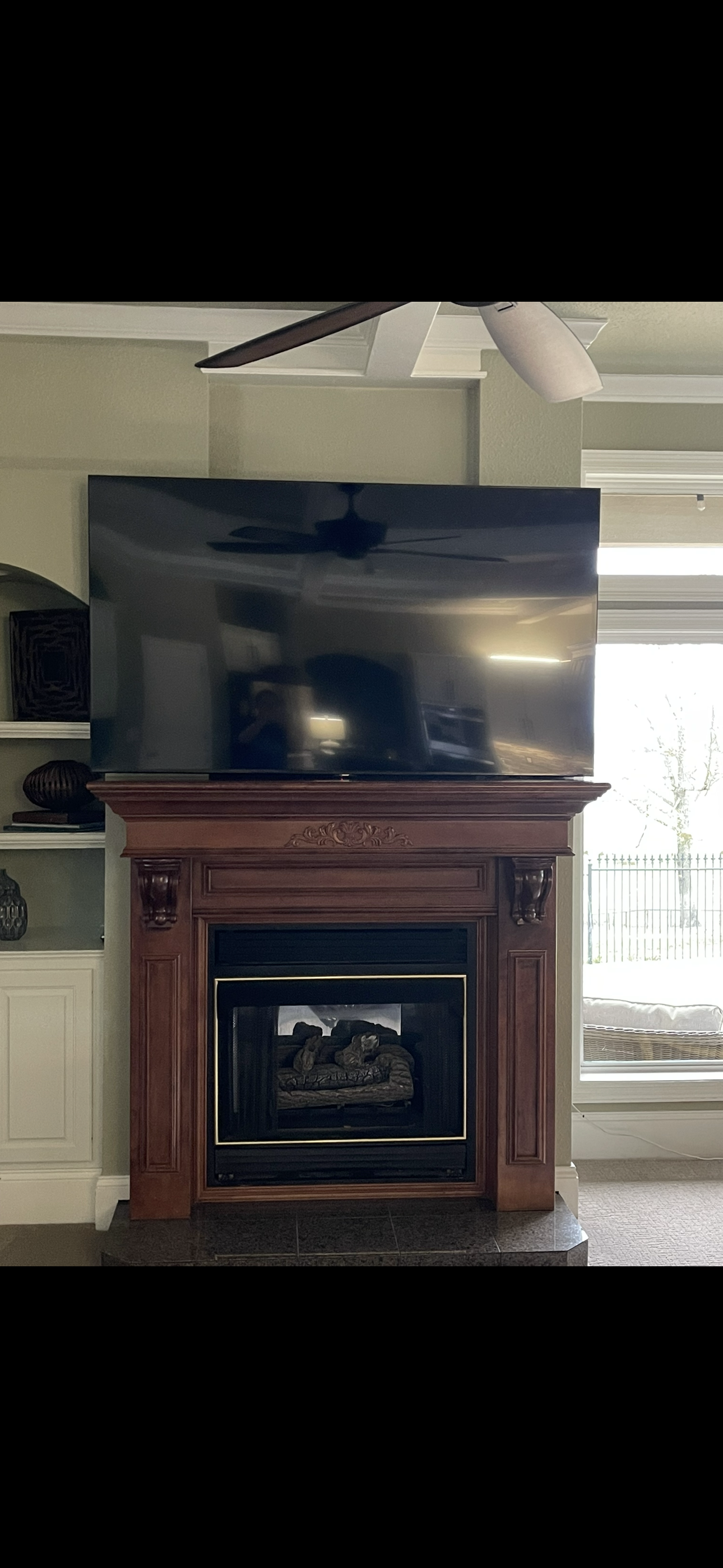 A living room with a fireplace and a flat screen tv on top of it.
