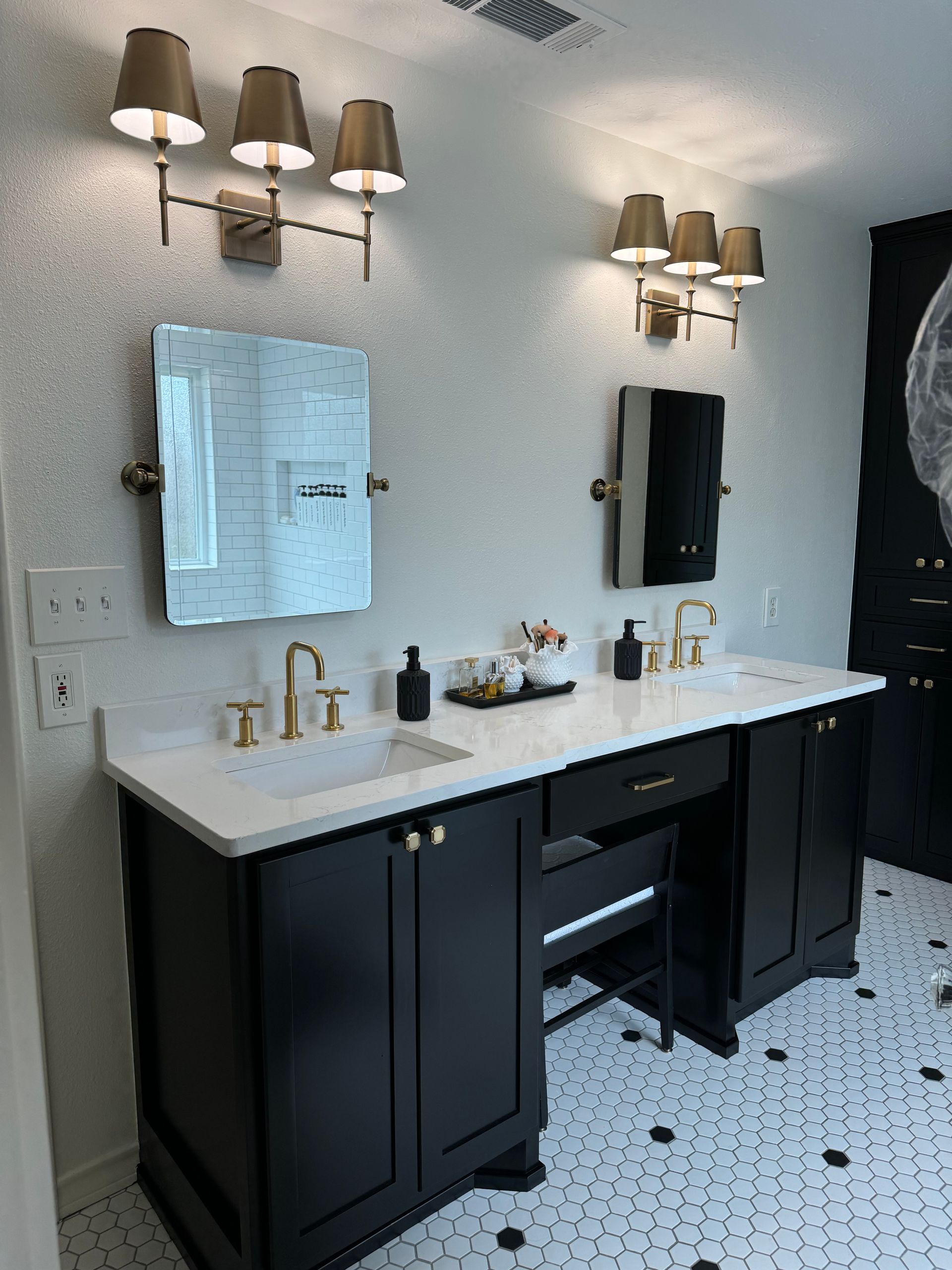 A bathroom with two sinks and a mirror.