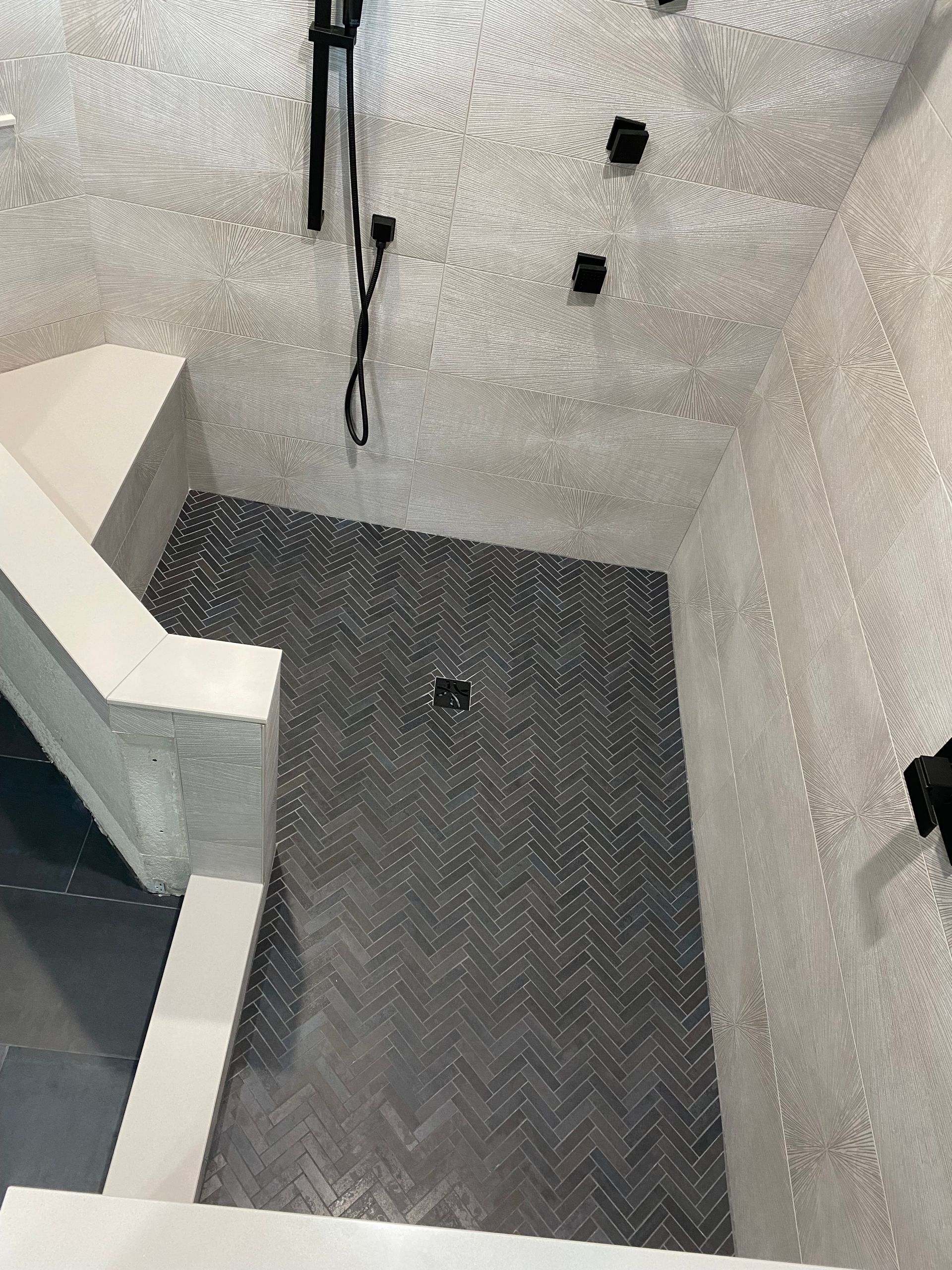 A bathroom with a shower and stairs leading up to it.