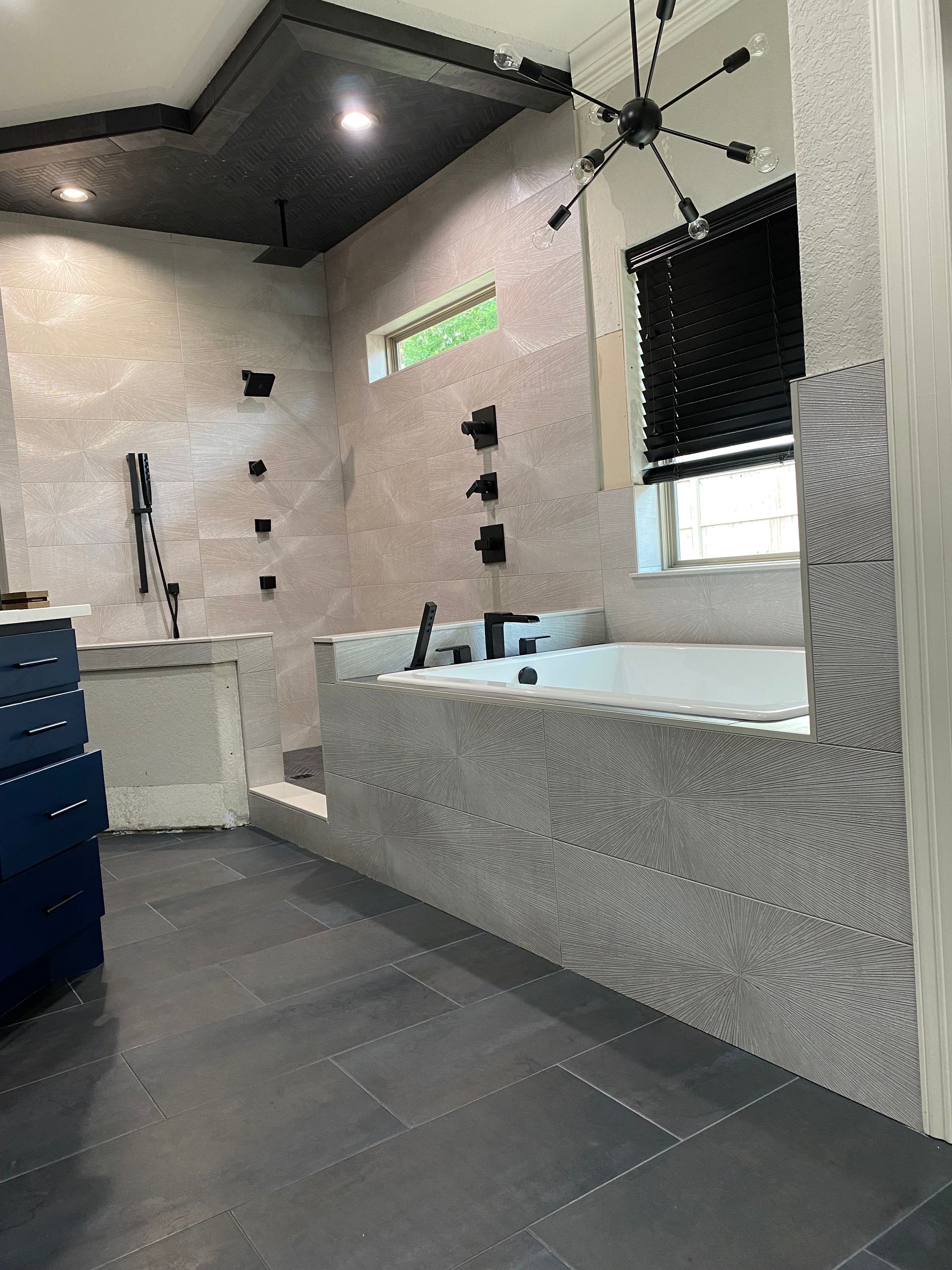 A bathroom with a bathtub and a shower.