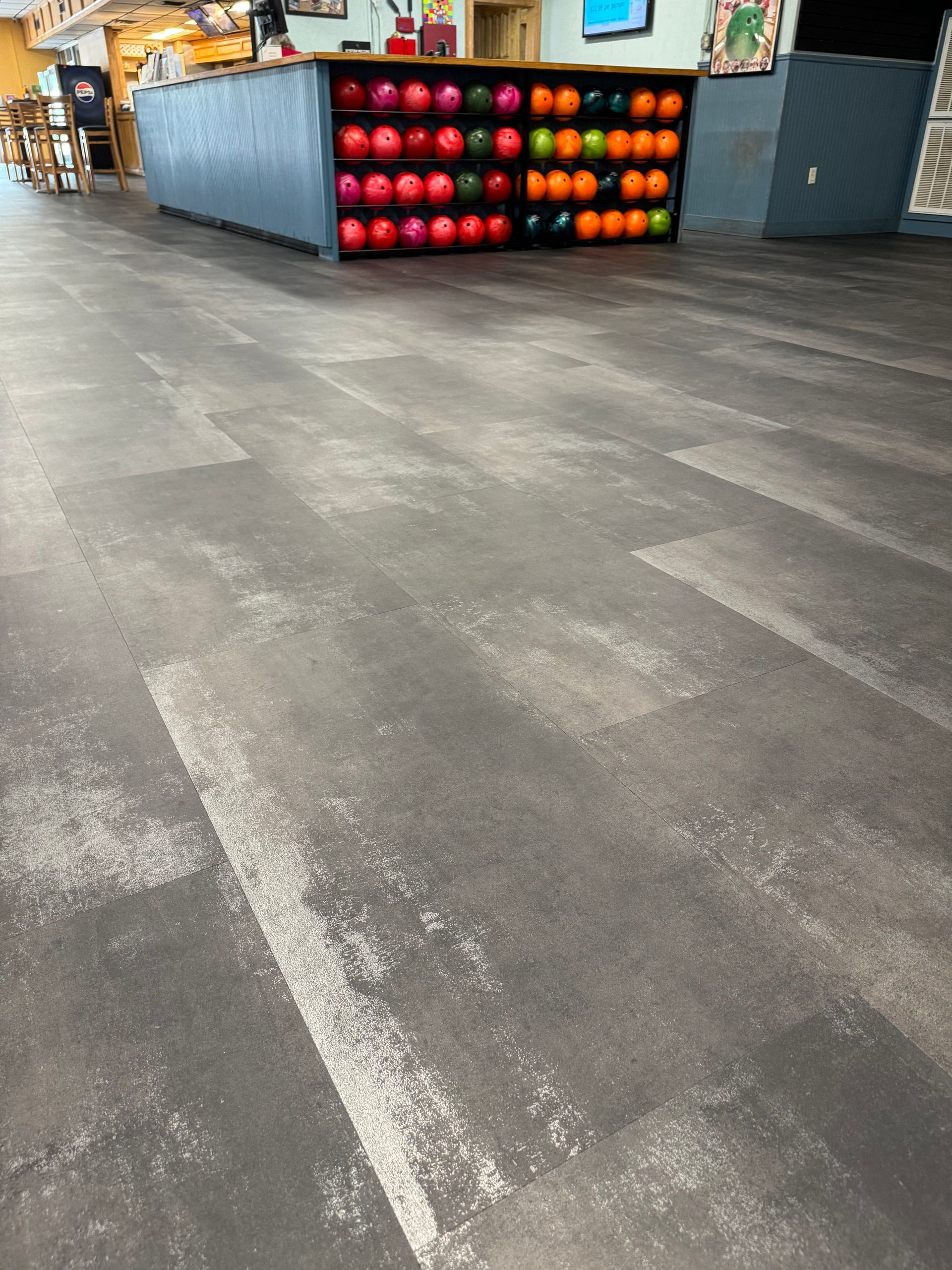 A room with a lot of balls on the floor and a counter.