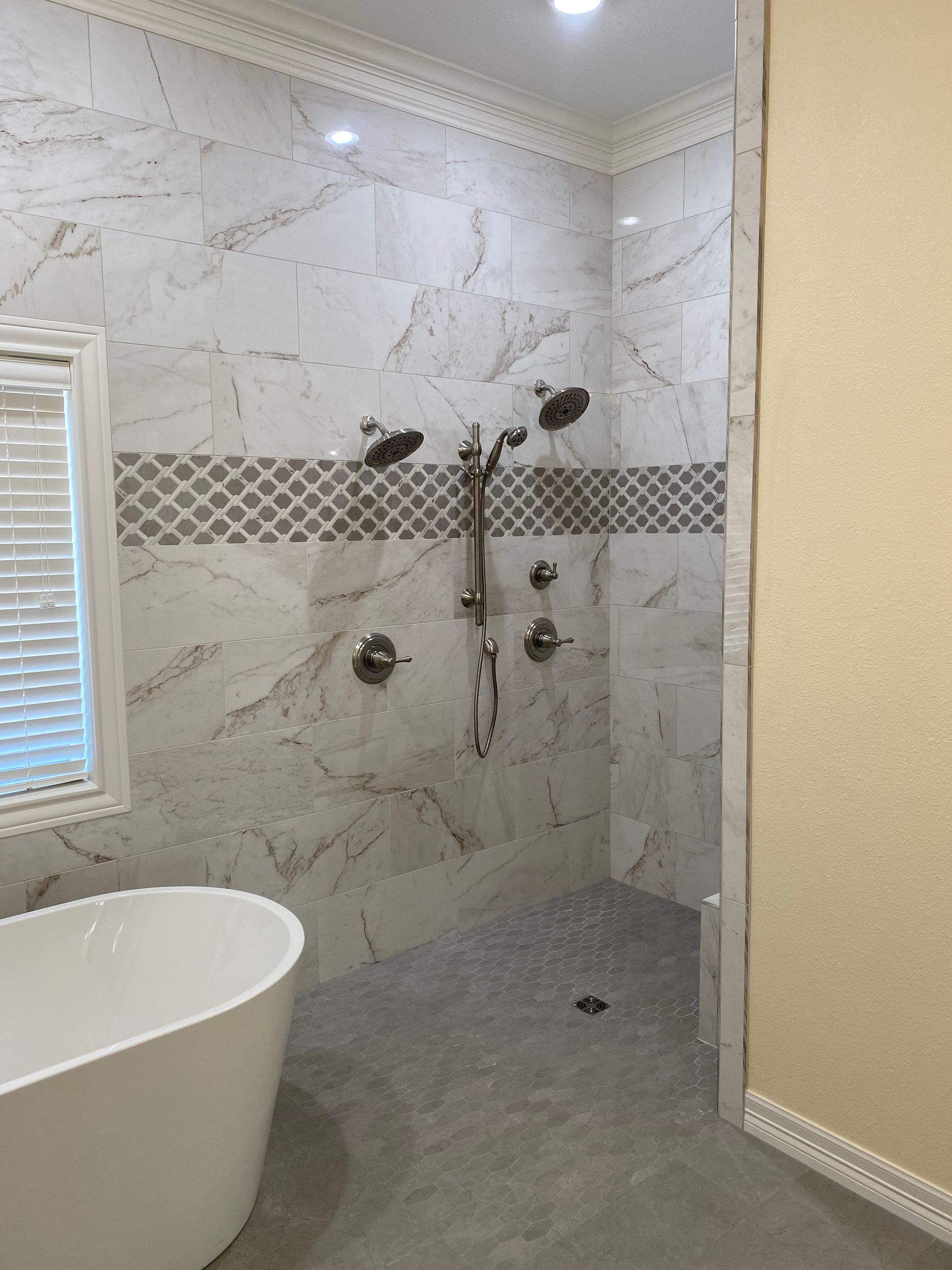 A bathroom with a tub and a walk in shower.