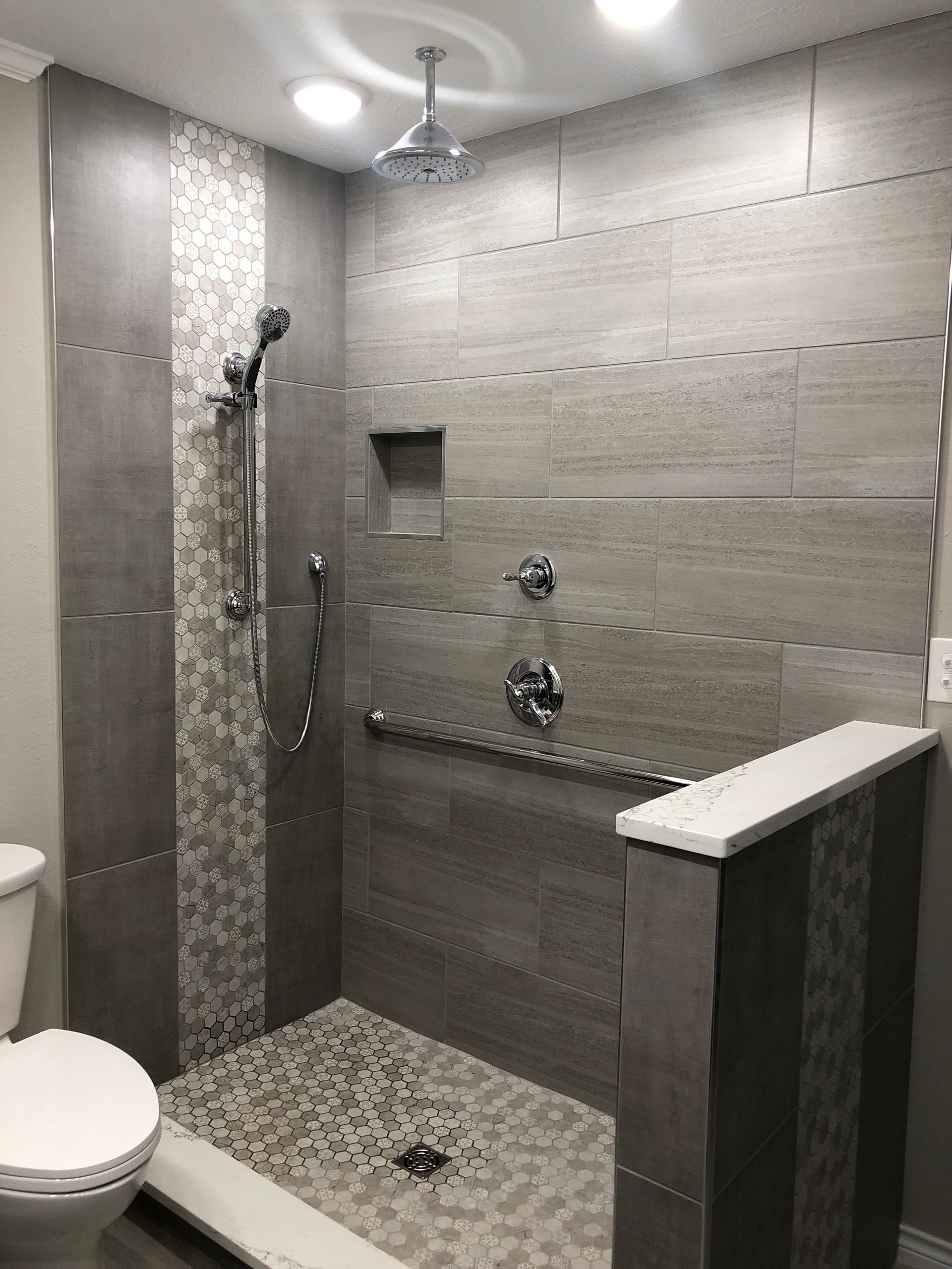 A bathroom with a walk in shower and a toilet.