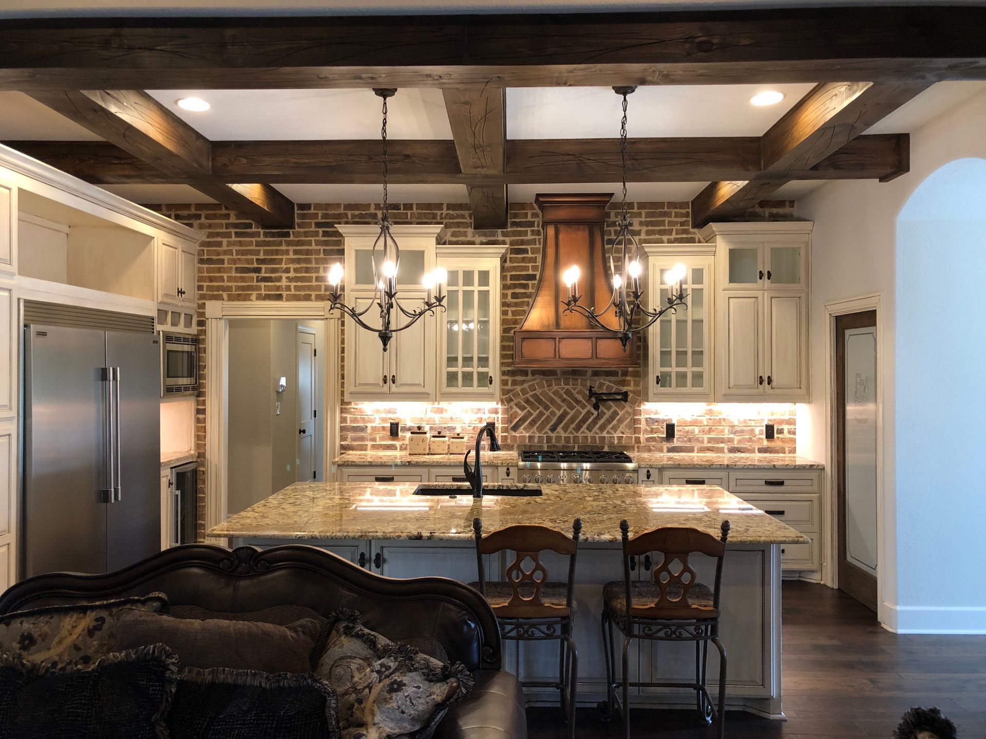 A kitchen with a large island and stainless steel appliances.