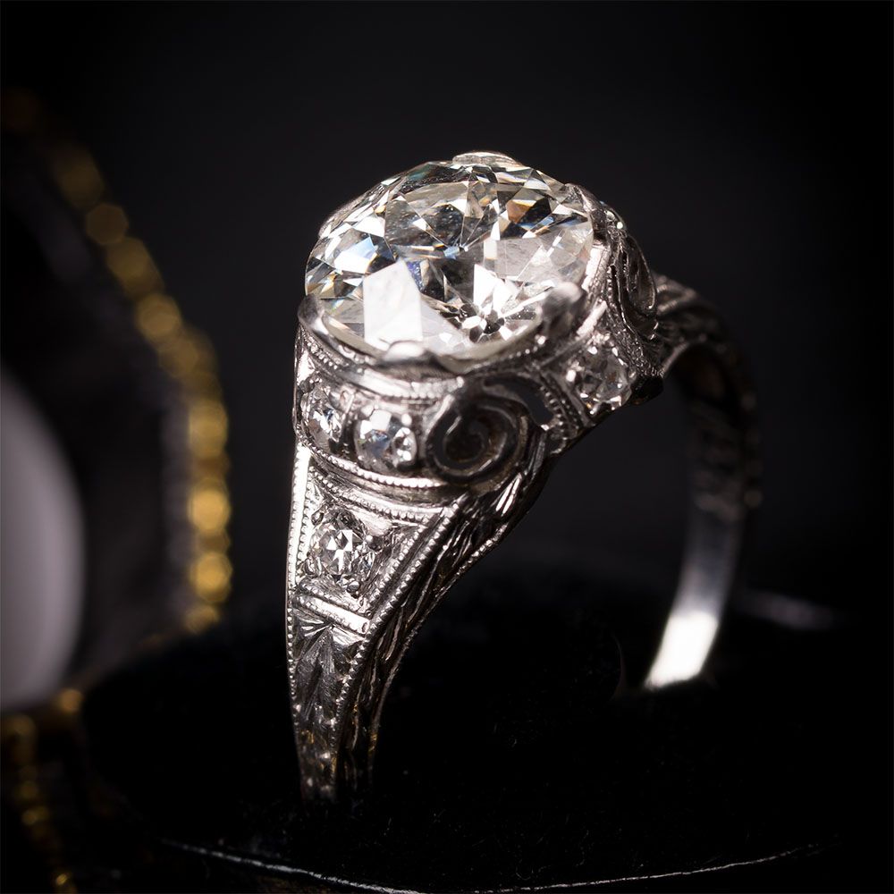 A diamond ring is sitting on a black surface