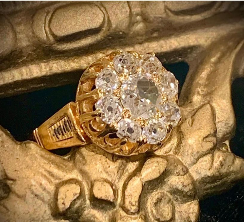 A gold ring with a large diamond in the center