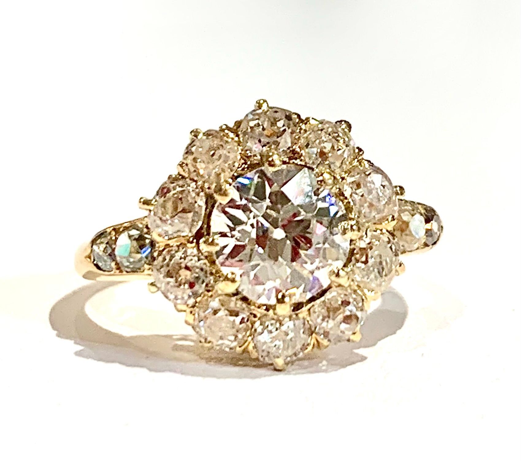 A close up of a diamond ring on a white surface.