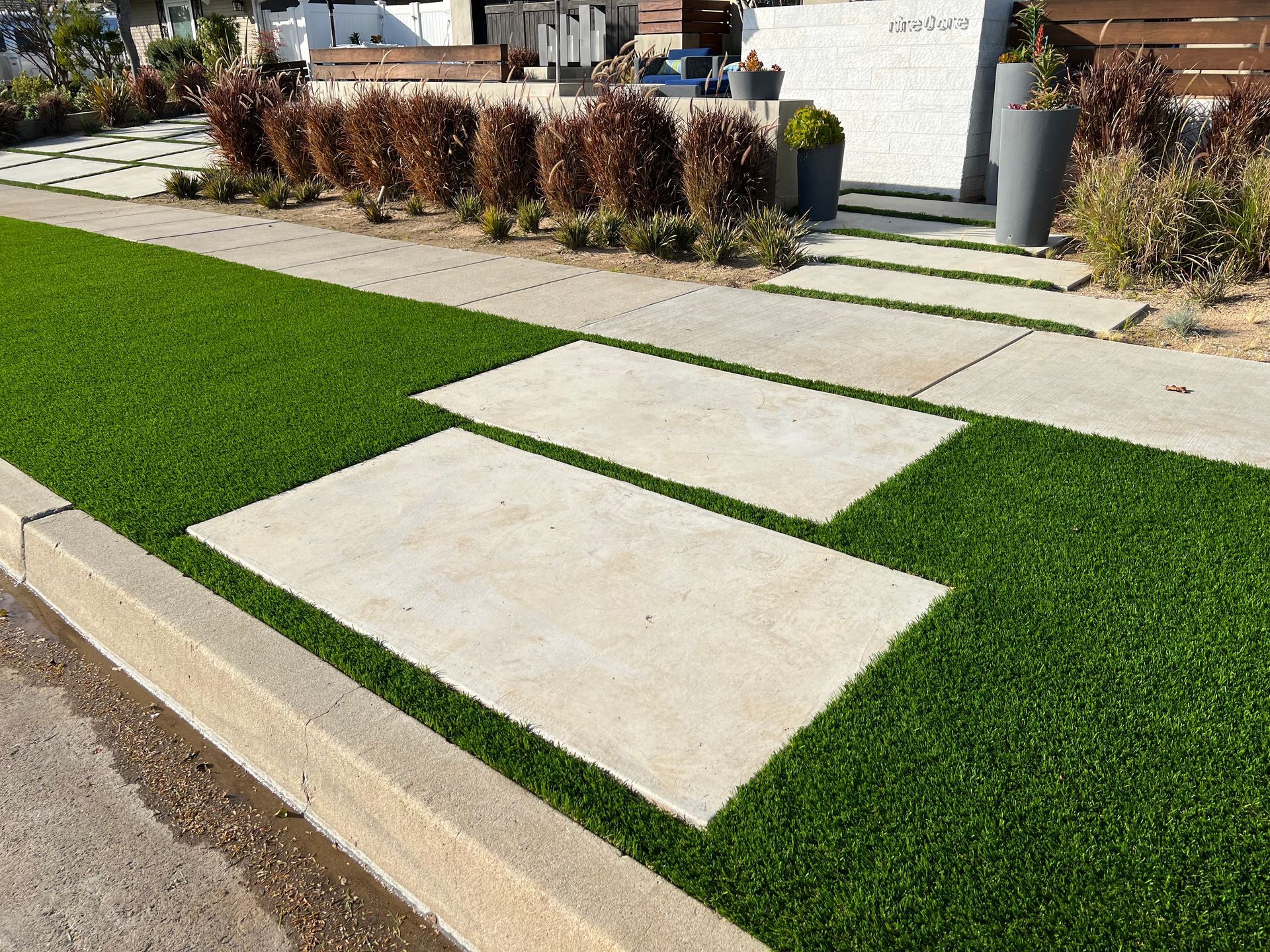 synthetic grass and step stones parkway