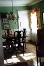 A dining room with a table and chairs in a house.