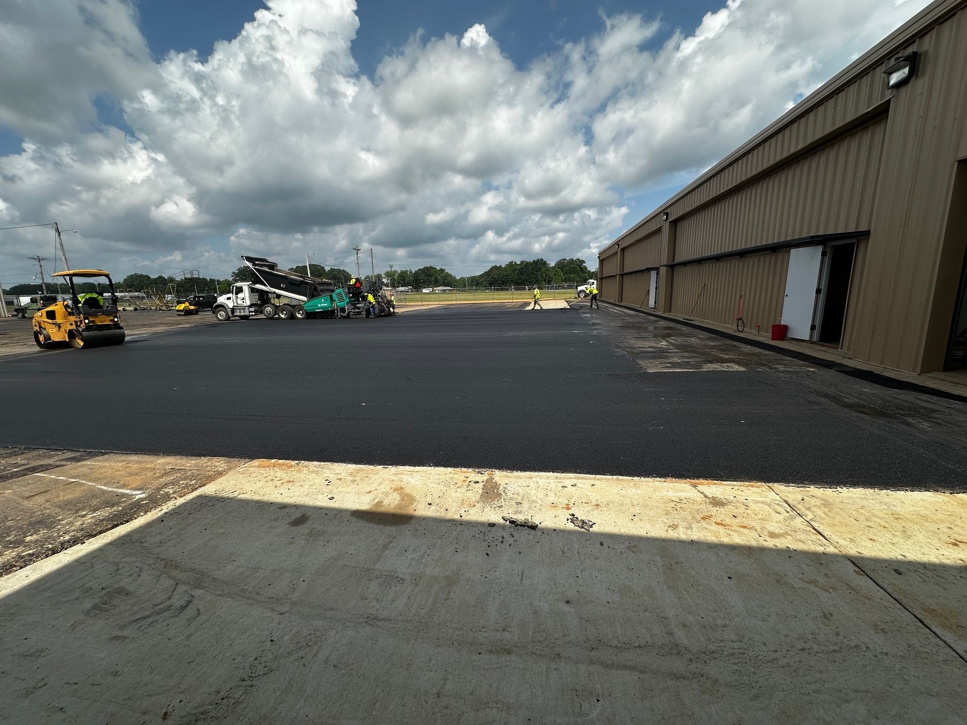 A private jet parked on an airport tarmac next to a building labeled 