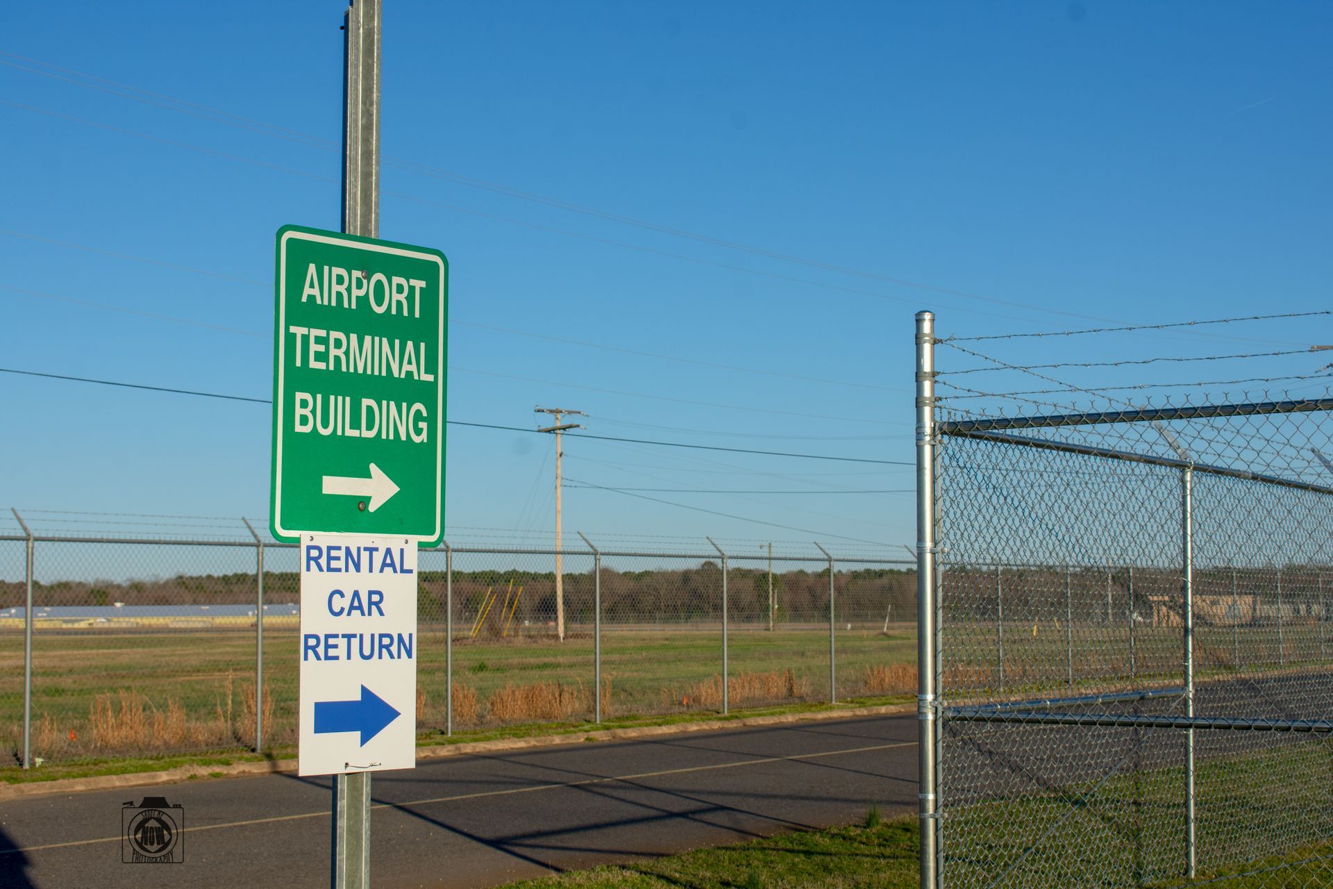 A fuel truck and a small utility vehicle parked near a private jet on an airport tarmac under a clear blue sky.