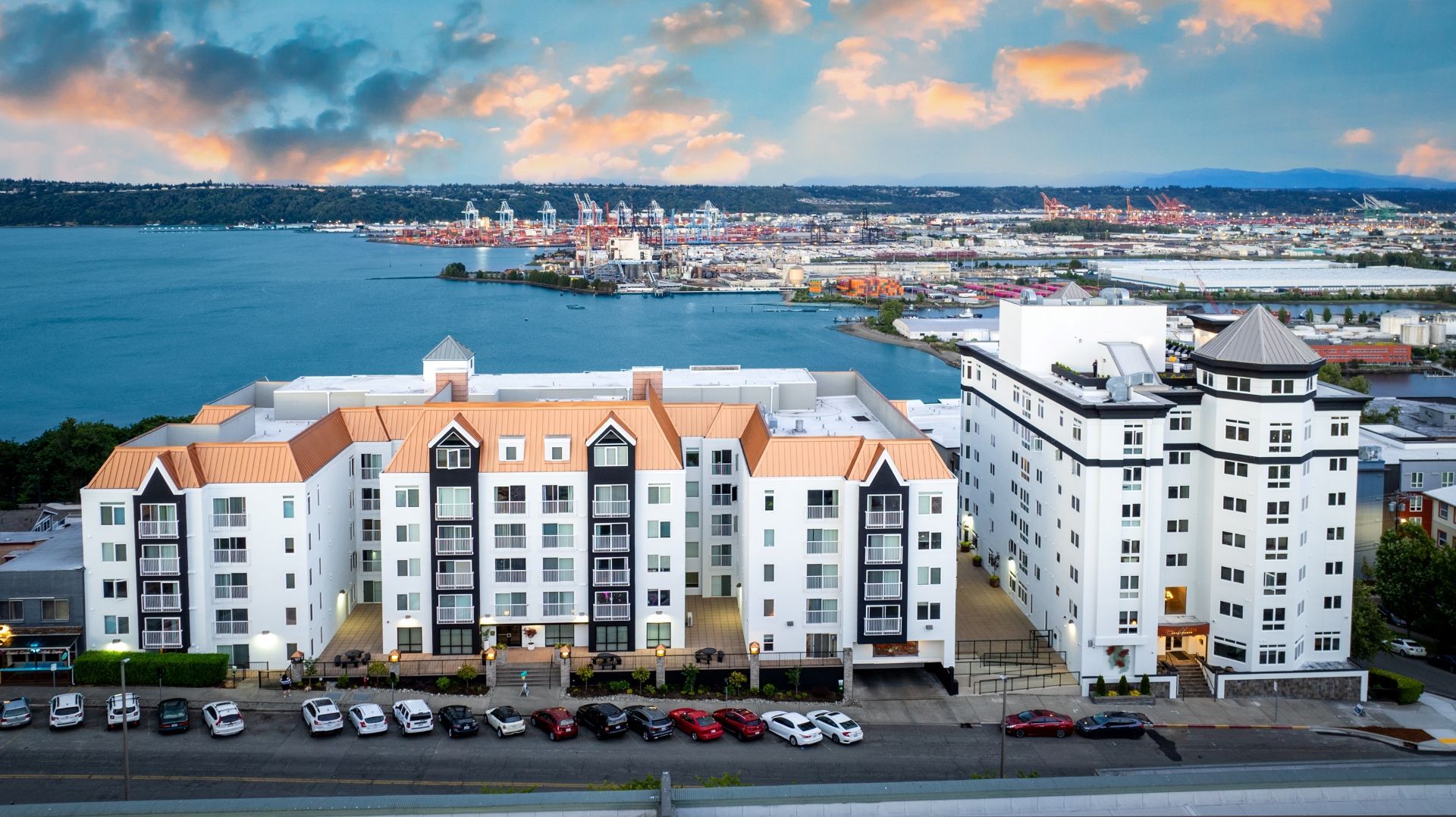 An aerial view of a large building next to a body of water.