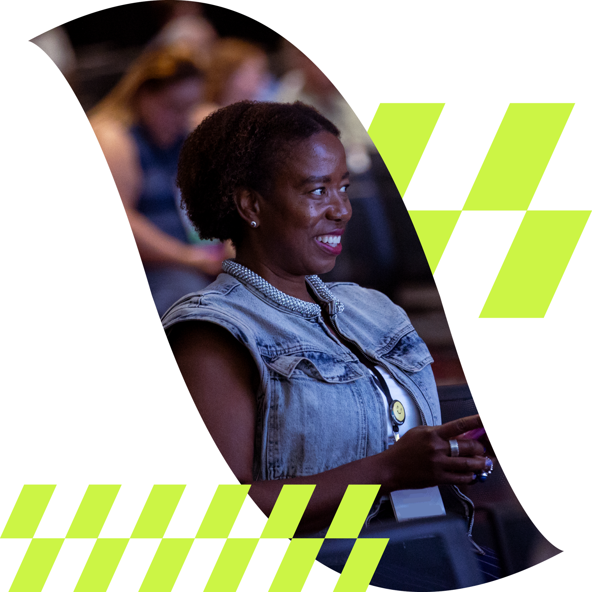 Smiling woman in a denim vest seated at an event, framed by white and neon green graphic shapes.