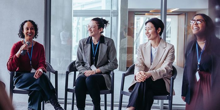 Woman speaking to fellow conference goers during workshop