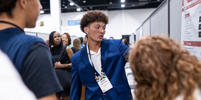 Person presenting poster at APA 2025