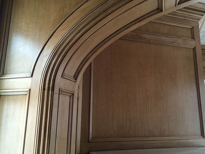 A wooden wall with a curved arch in the middle
