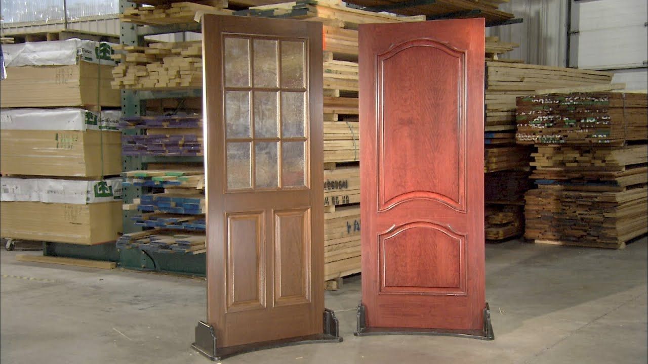 Two wooden doors are sitting next to each other in a warehouse