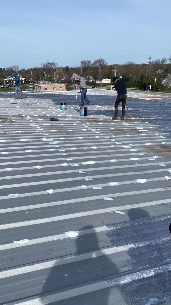 A group of people are working on a roof.