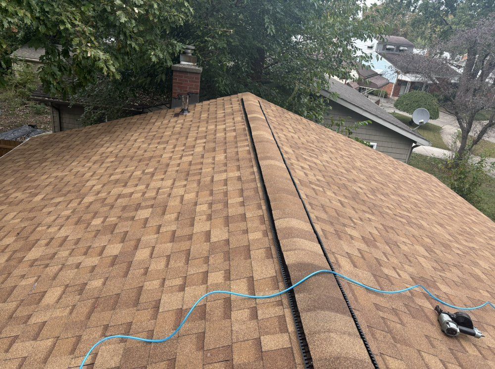The roof of a house with a satellite dish on it.