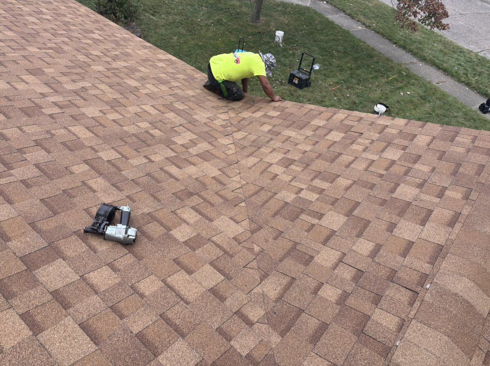 A man is working on the roof of a house.