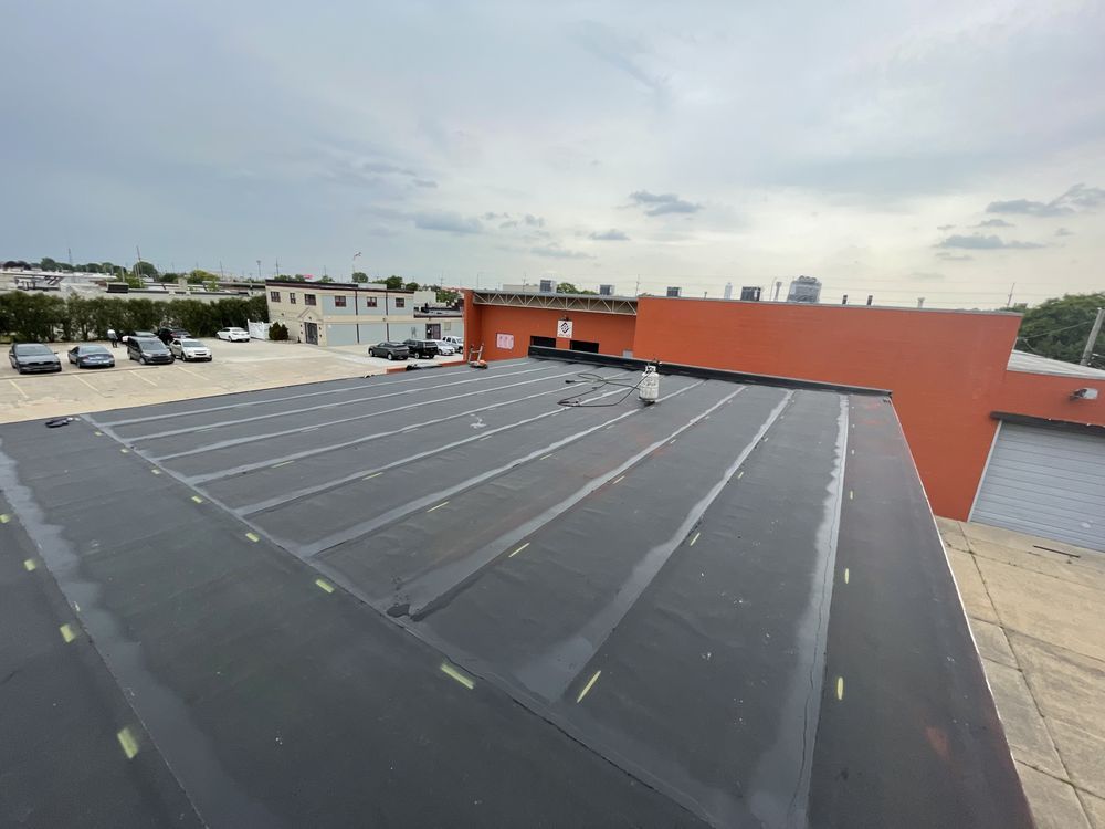 An aerial view of a parking lot on the roof of a building.