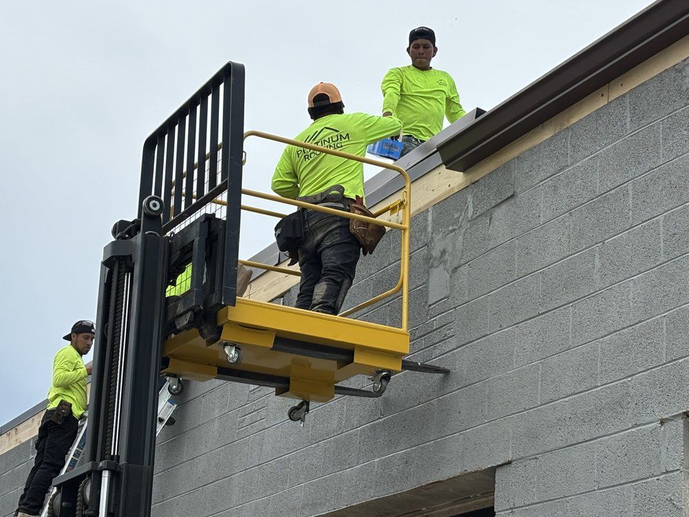 A group of construction workers are working on the side of a building.