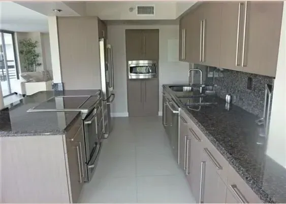 A kitchen with stainless steel appliances and granite counter tops