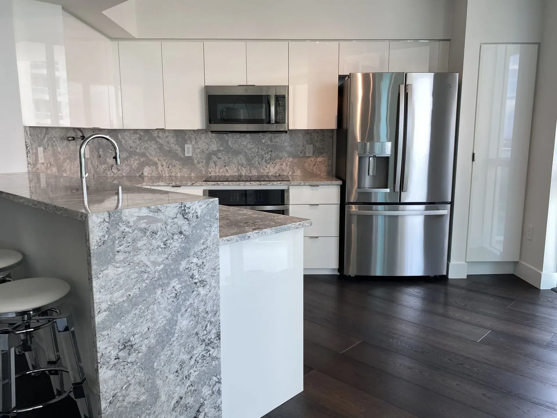 A kitchen with stainless steel appliances and granite counter tops