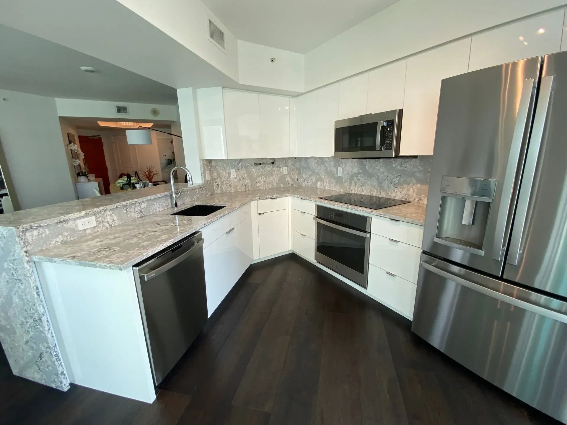 A kitchen with white cabinets and stainless steel appliances