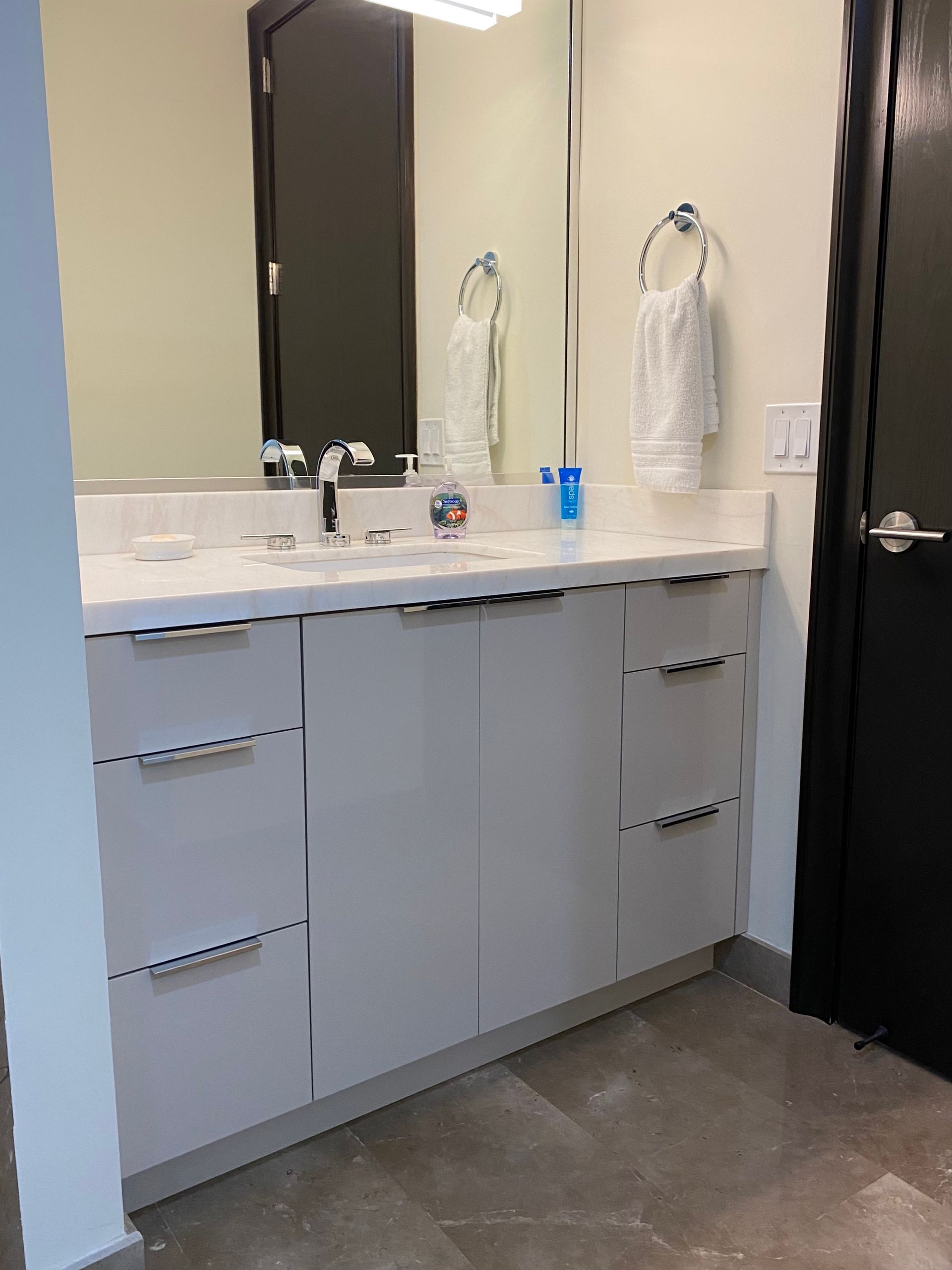 Bathroom vanity with a single sink with a quartz countertop and a mirror