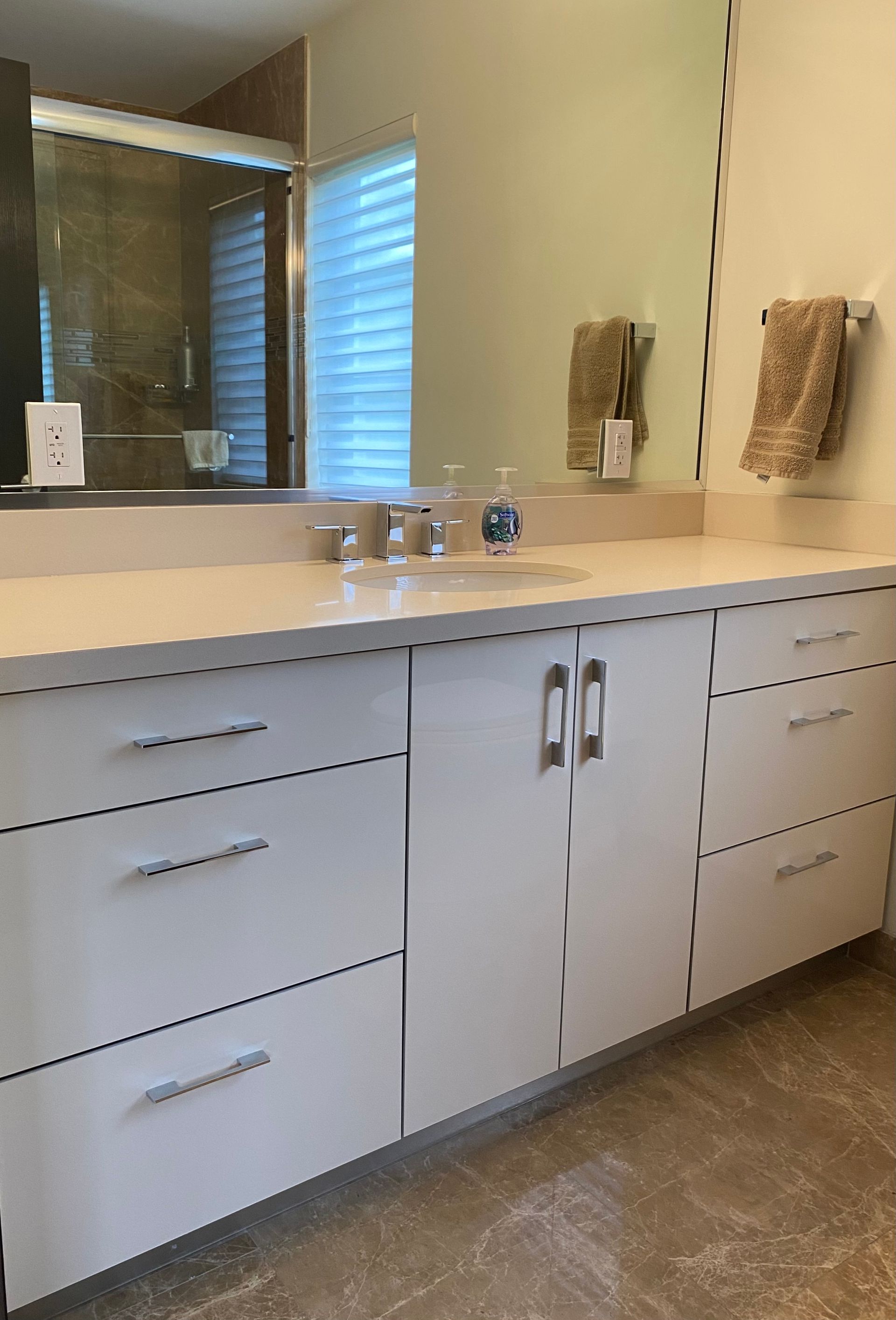 Bathroom vanity cabinet with drawers and doors and a full size mirror