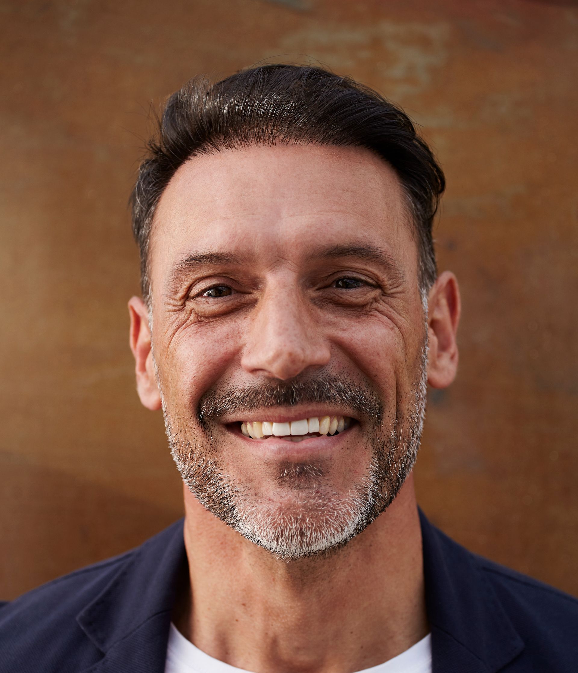 A man with a beard is smiling for the camera.
