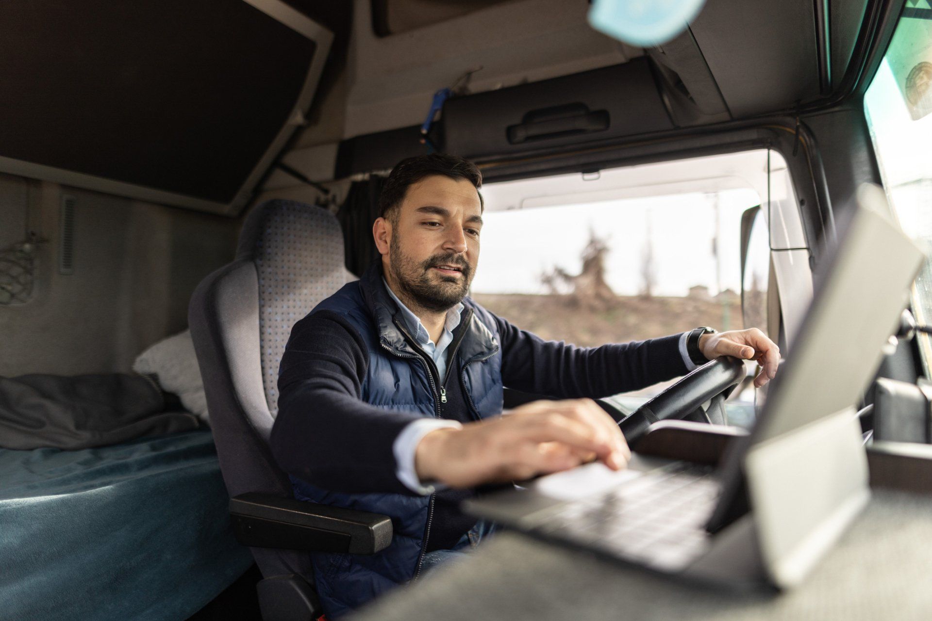 Truck Driver Typing on Digital Tablet – Houston TX – Ro Watson