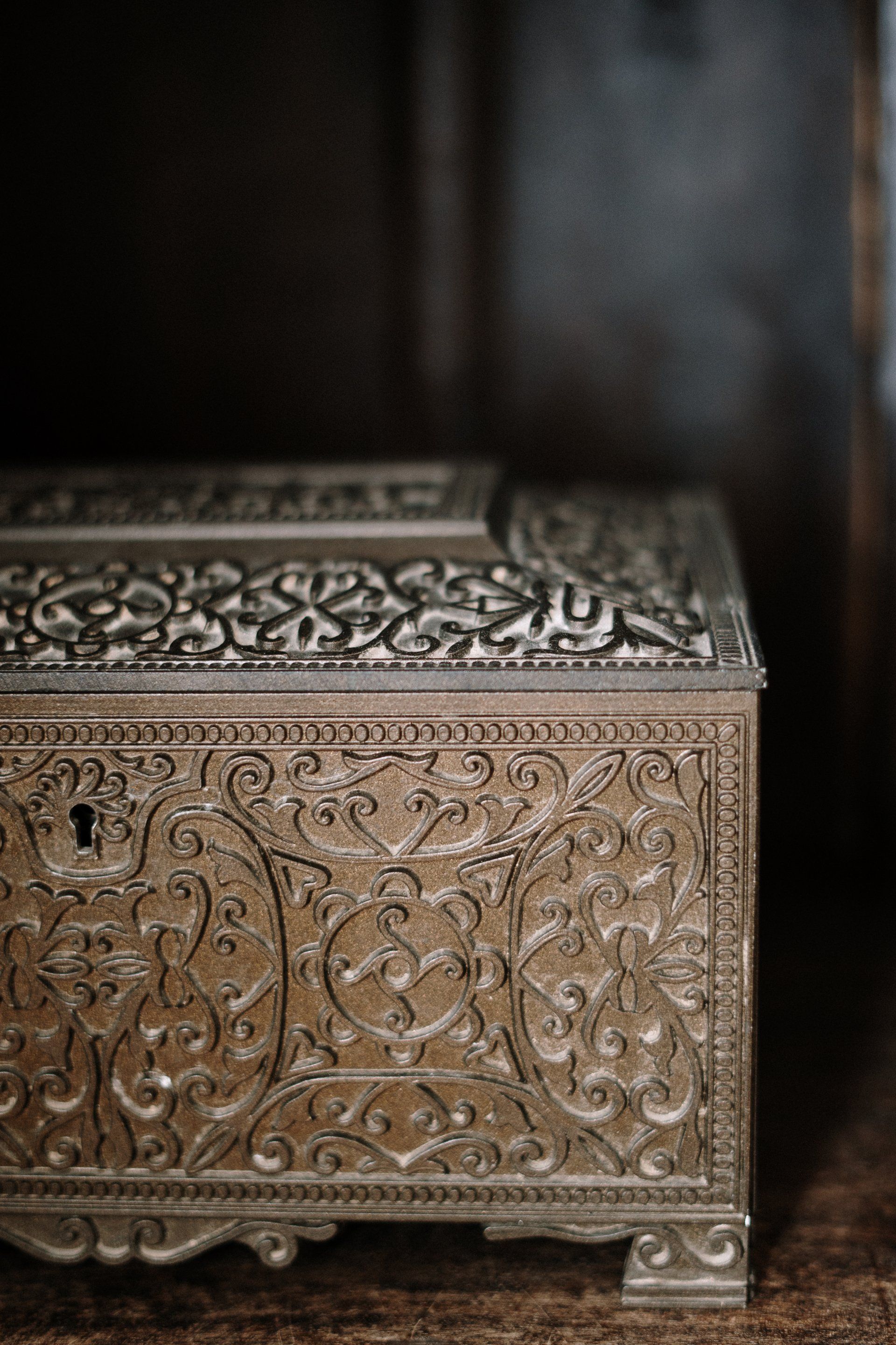 A silver treasure chest is sitting on a wooden table.