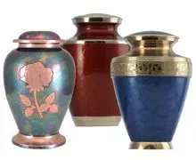 Three different colored urns are sitting next to each other on a white background.