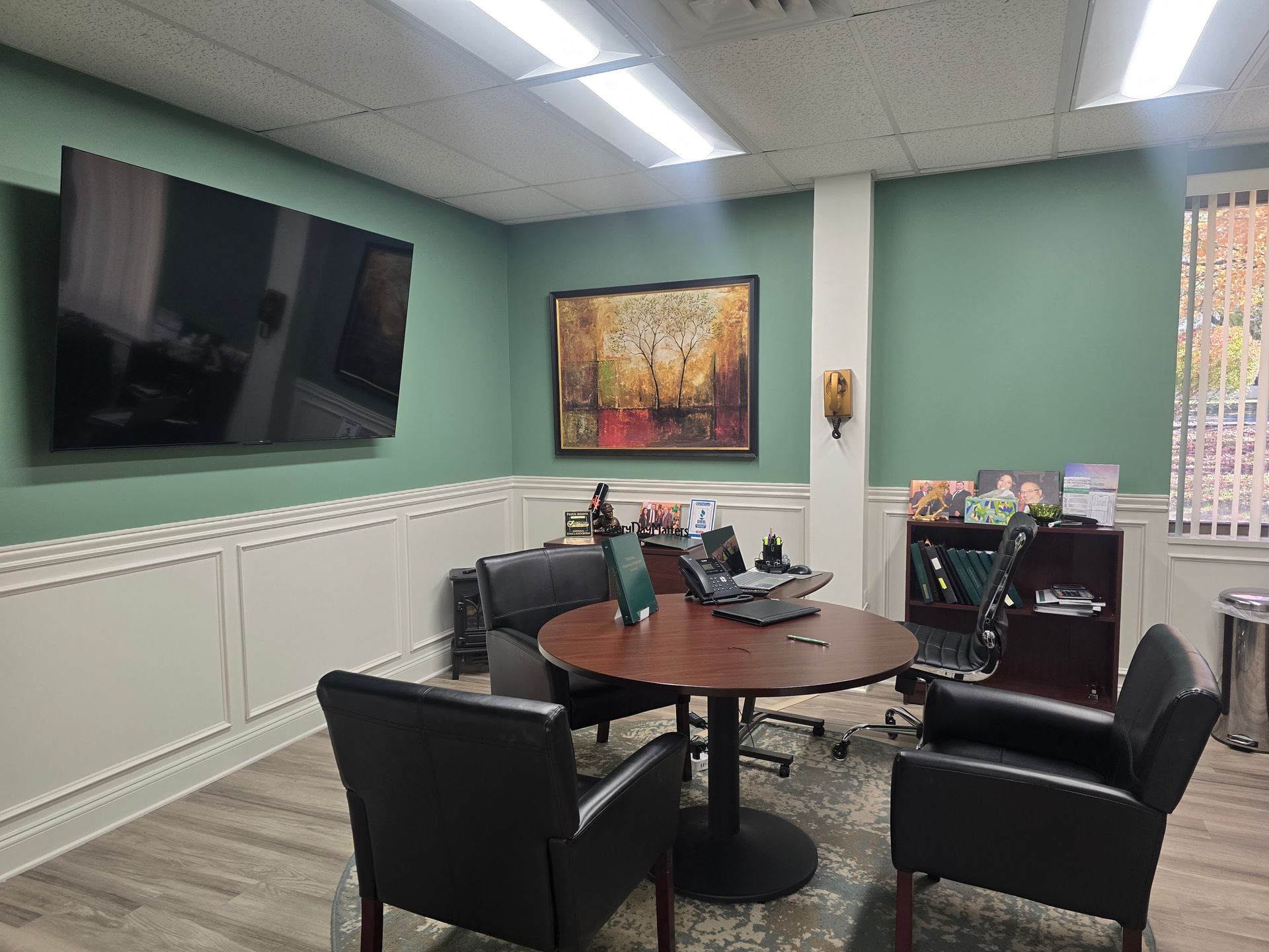 A black and white photo of an older man holding glasses.