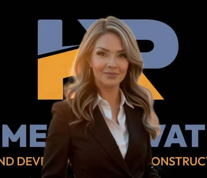 Woman in blazer in front of a logo. HR, renovation, and construction written on logo.